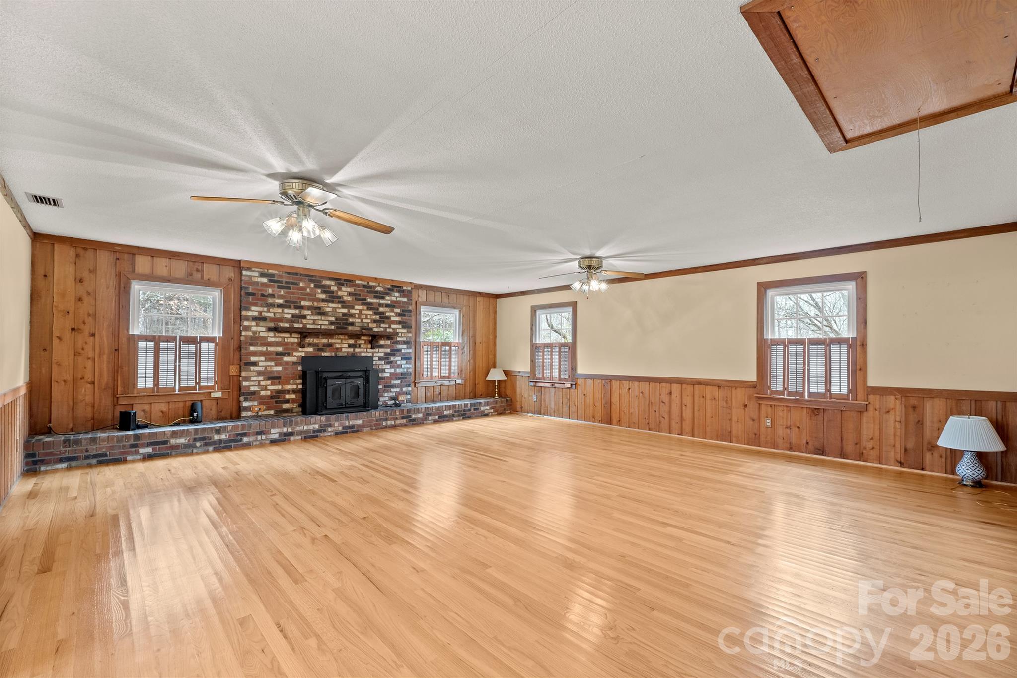 333 Sandy Ford Road Mount Holly, NC 28120 - Photo 4 of 42 a view of an empty room with a fireplace and a window
