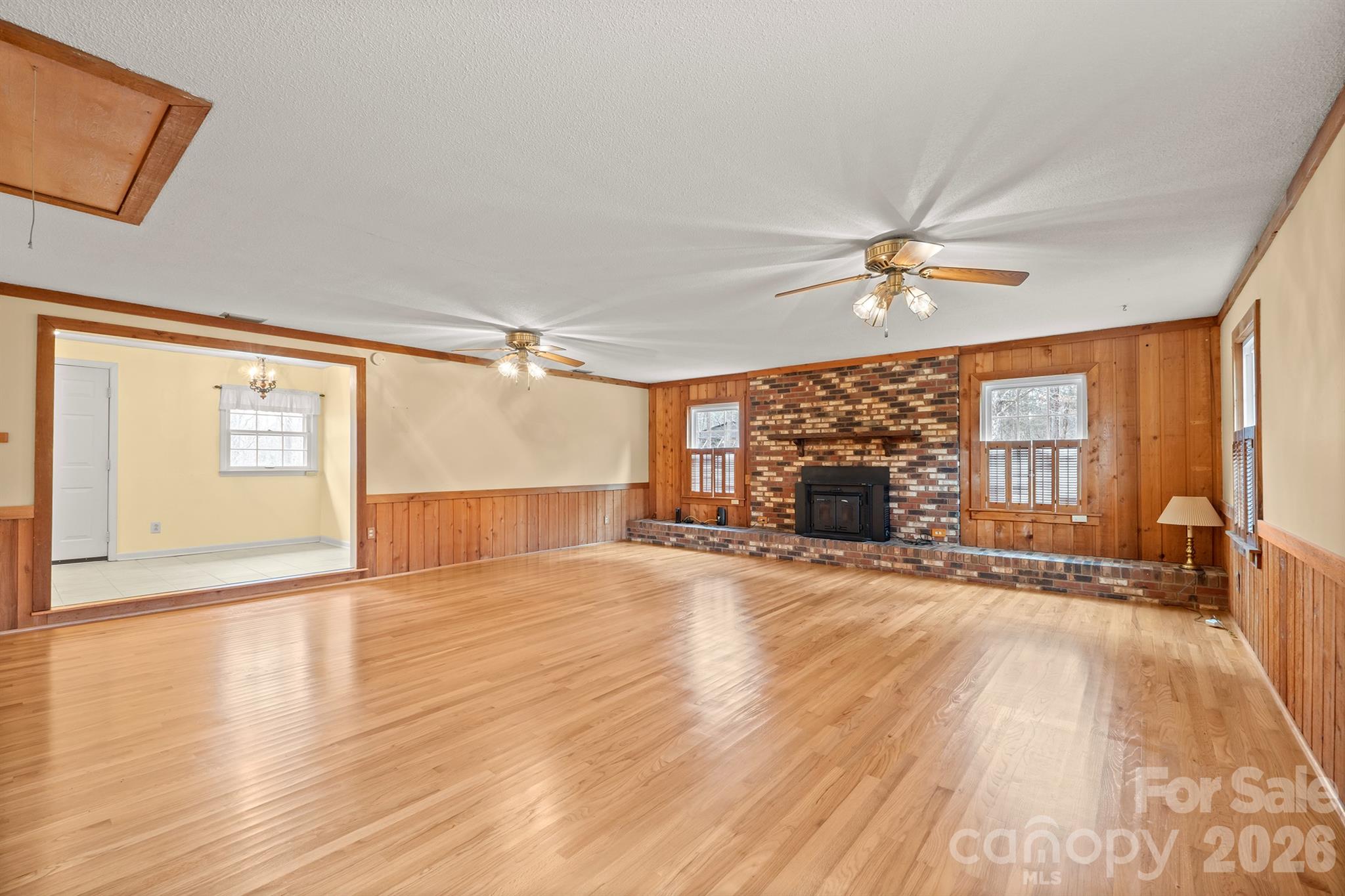 333 Sandy Ford Road Mount Holly, NC 28120 - Photo 6 of 42 a view of an empty room with a window and wooden floor