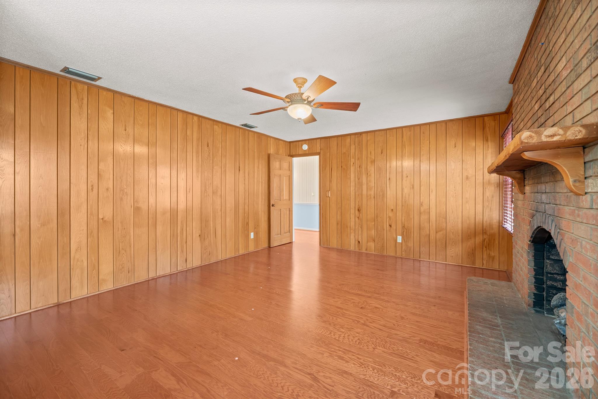 333 Sandy Ford Road Mount Holly, NC 28120 - Photo 8 of 42 a view of empty room with wooden floor and fan