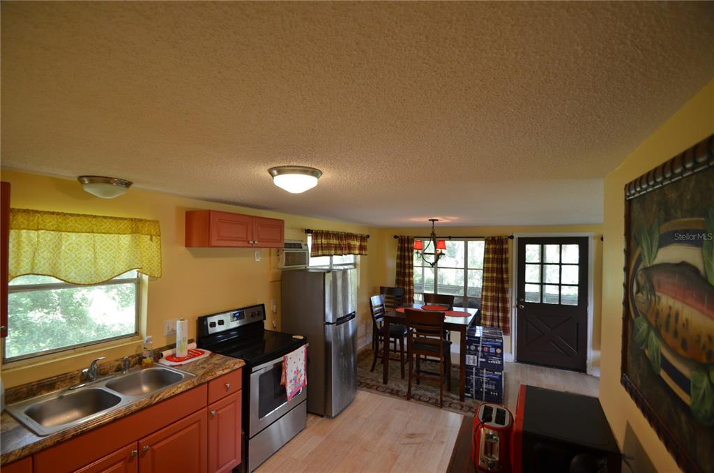 0 Southeast Highway 31 Arcadia, FL 34266 - Photo 8 of 45 a kitchen with stainless steel appliances a stove top oven a sink a dining table and chairs