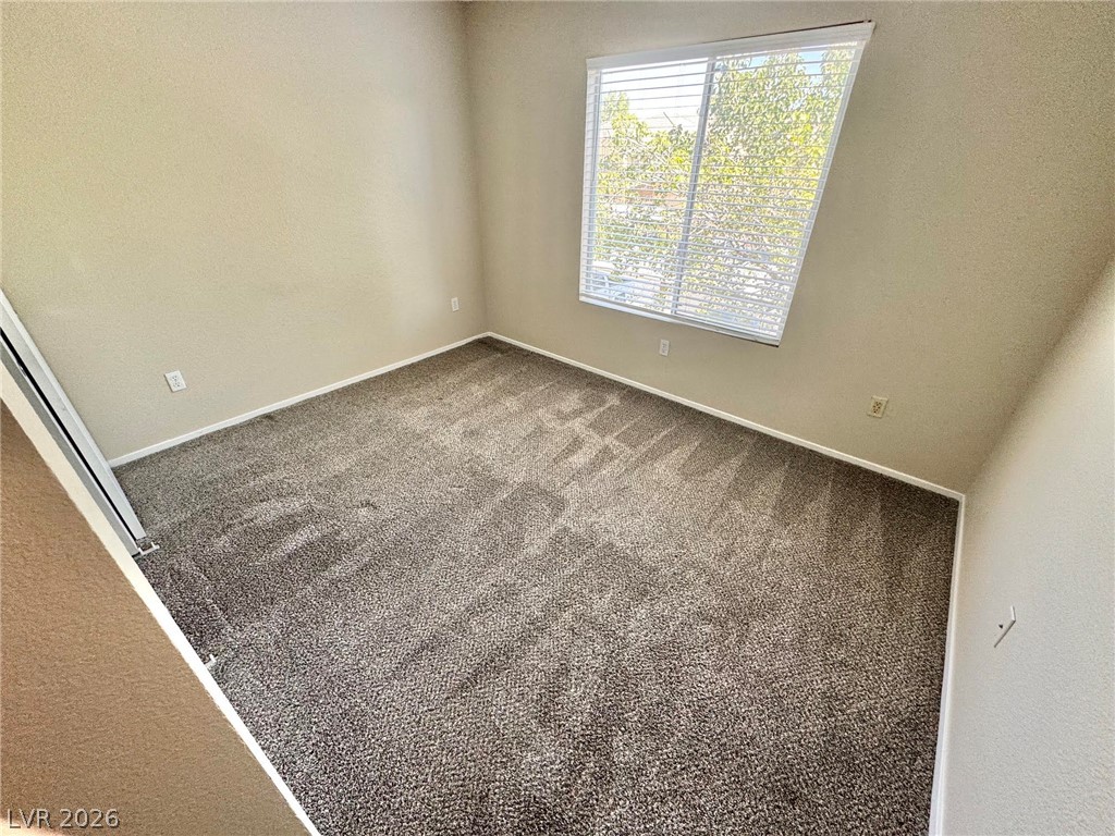 8070 West Russell Road, Unit 2121 Las Vegas, NV 89113 - Photo 6 of 22 Natural light filters into this quiet room, featuring vaulted ceilings and fresh carpeting.