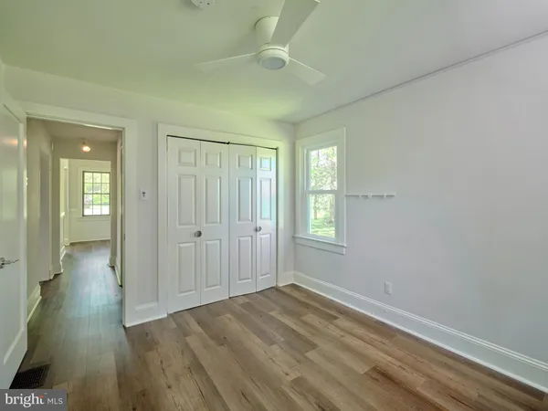 a view of a room with wooden floor and windows