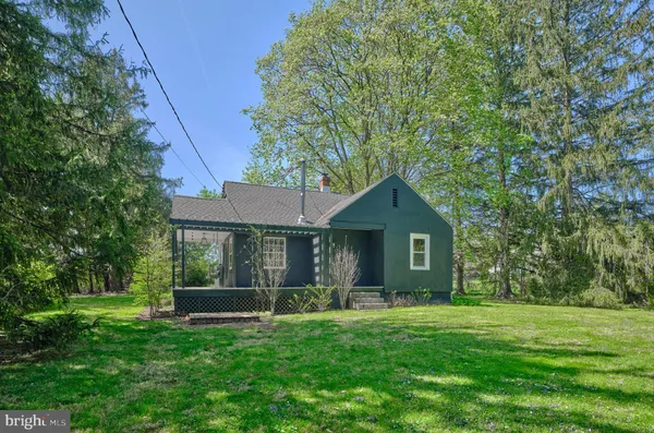 a view of an house with backyard space and garden