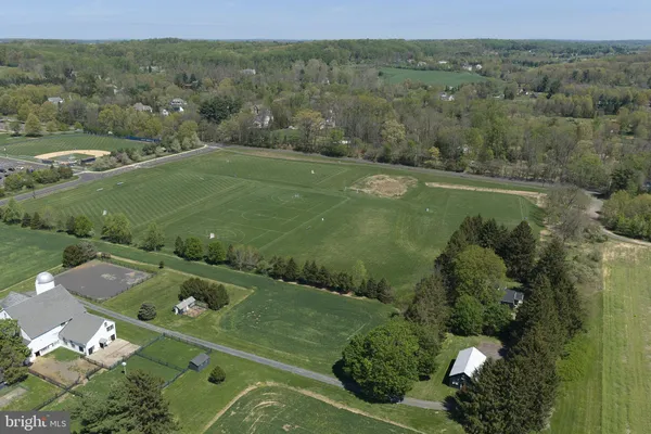 an aerial view of a golf course with a lake view