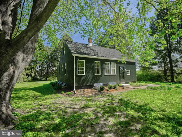 a front view of a house with garden and porch