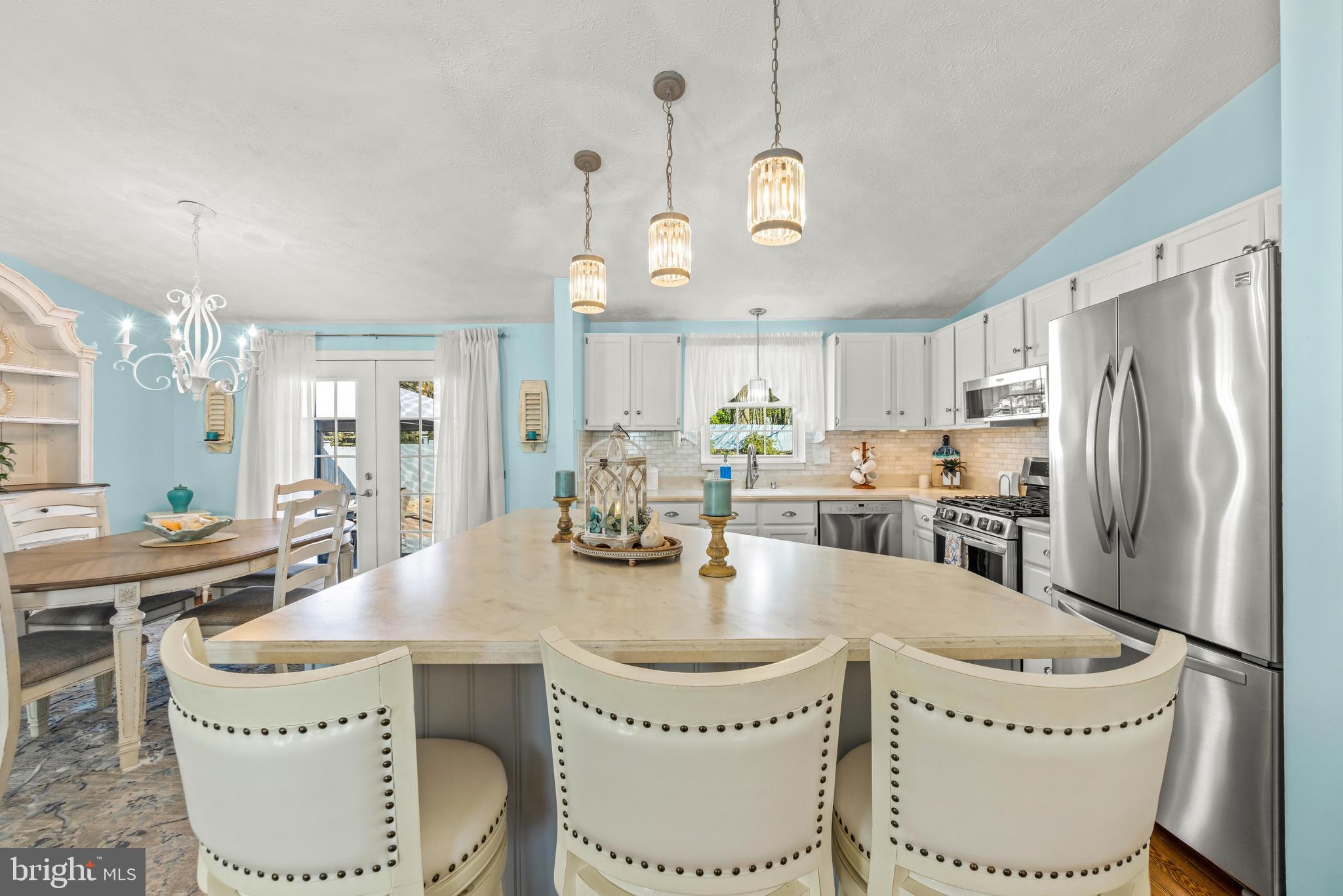 15 Yew Road Baltimore, MD 21221 - Photo 15 of 61 a kitchen with a dining table a sink cabinets and stainless steel appliances