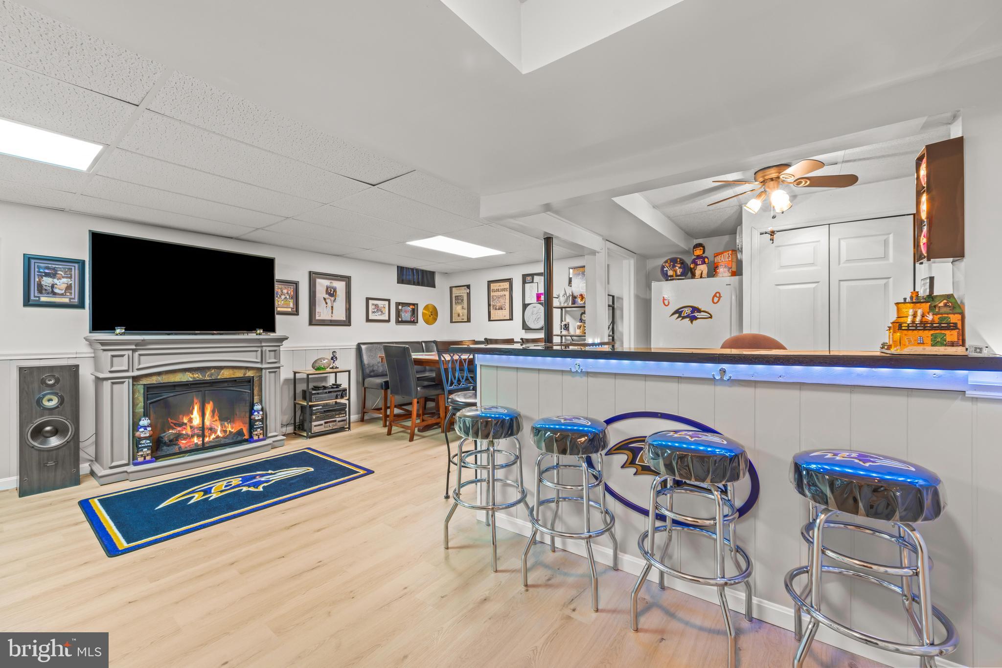15 Yew Road Baltimore, MD 21221 - Photo 37 of 61 a living room with furniture a fireplace and a flat screen tv
