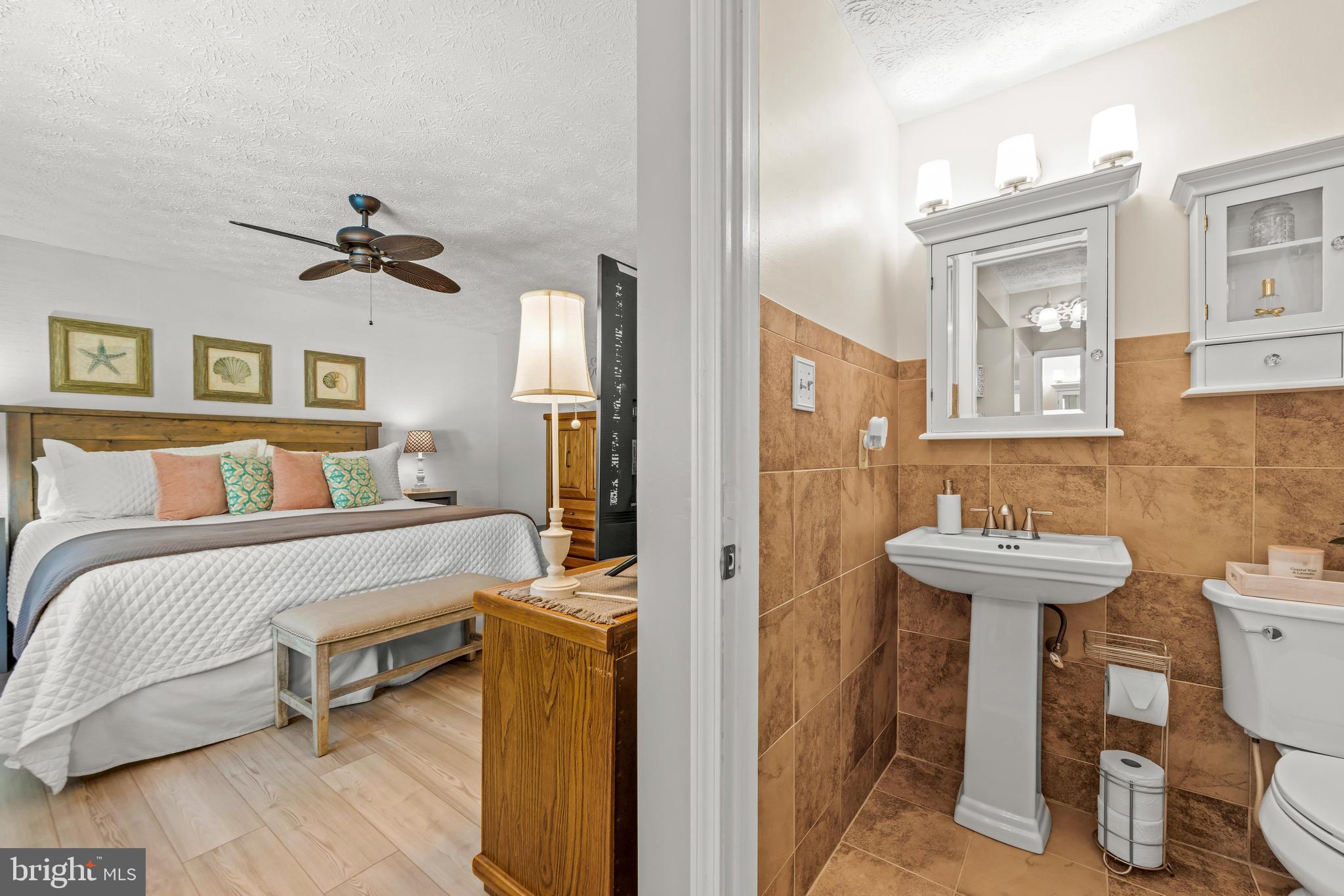 15 Yew Road Baltimore, MD 21221 - Photo 46 of 61 a bathroom with a sink a mirror and a toilet