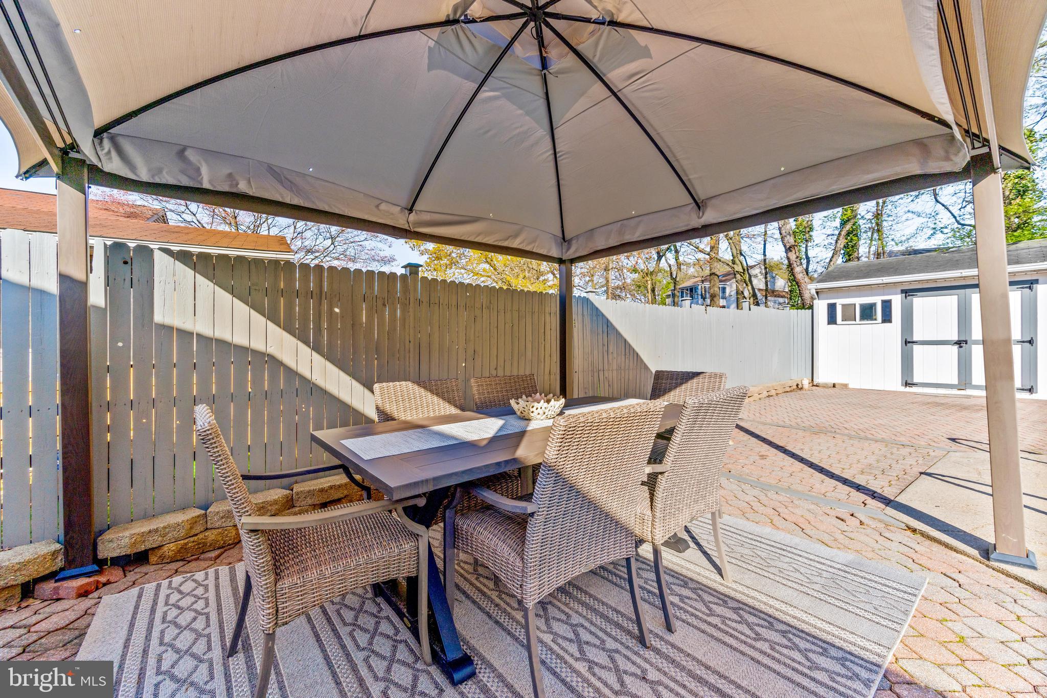 15 Yew Road Baltimore, MD 21221 - Photo 54 of 61 a patio with wooden floor a yard a table and chairs