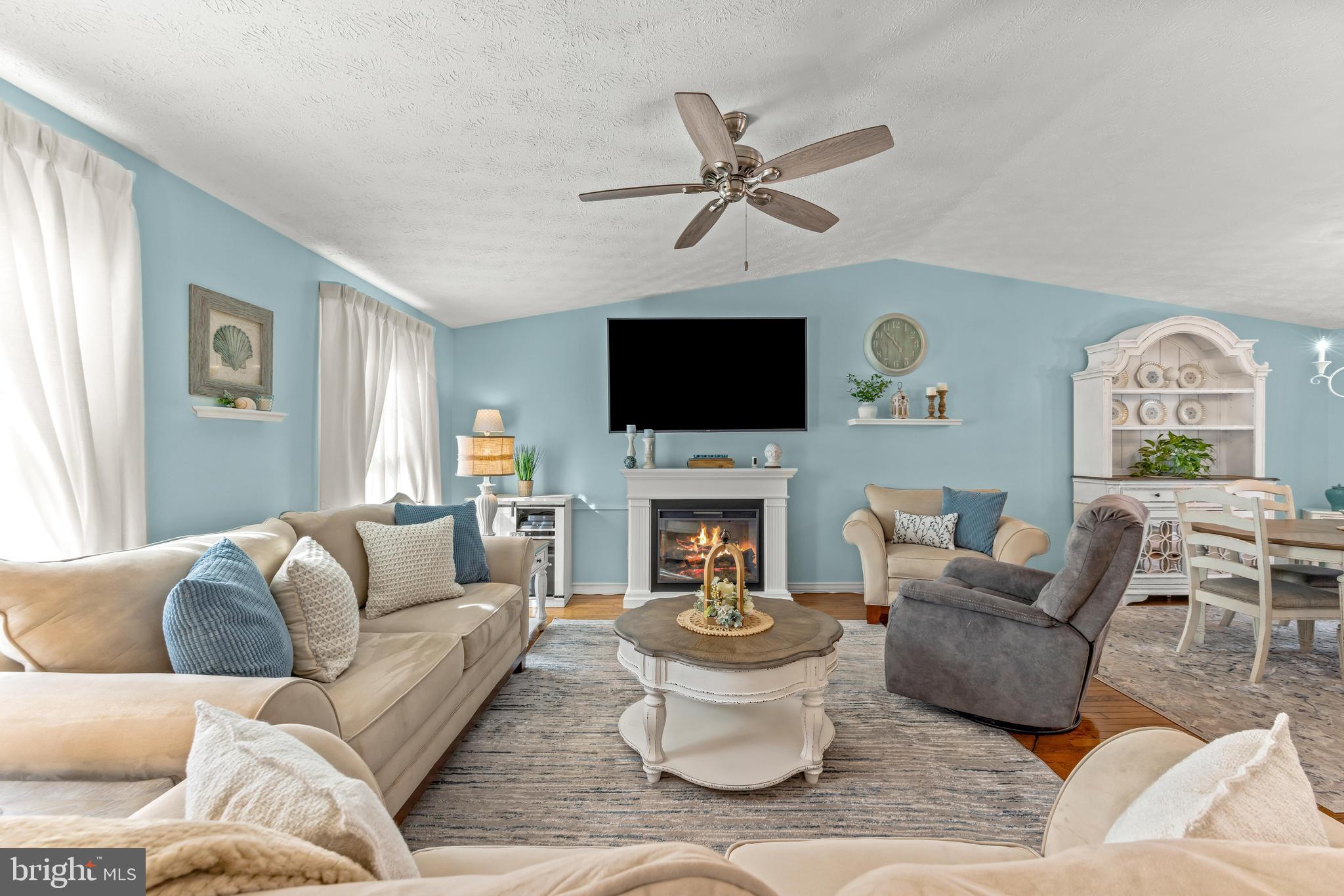 15 Yew Road Baltimore, MD 21221 - Photo 8 of 61 a living room with furniture a fireplace and a flat screen tv