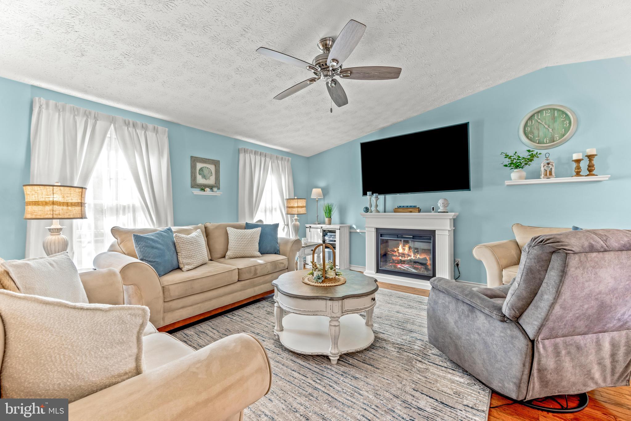 15 Yew Road Baltimore, MD 21221 - Photo 9 of 61 a living room with furniture a fireplace and a flat screen tv