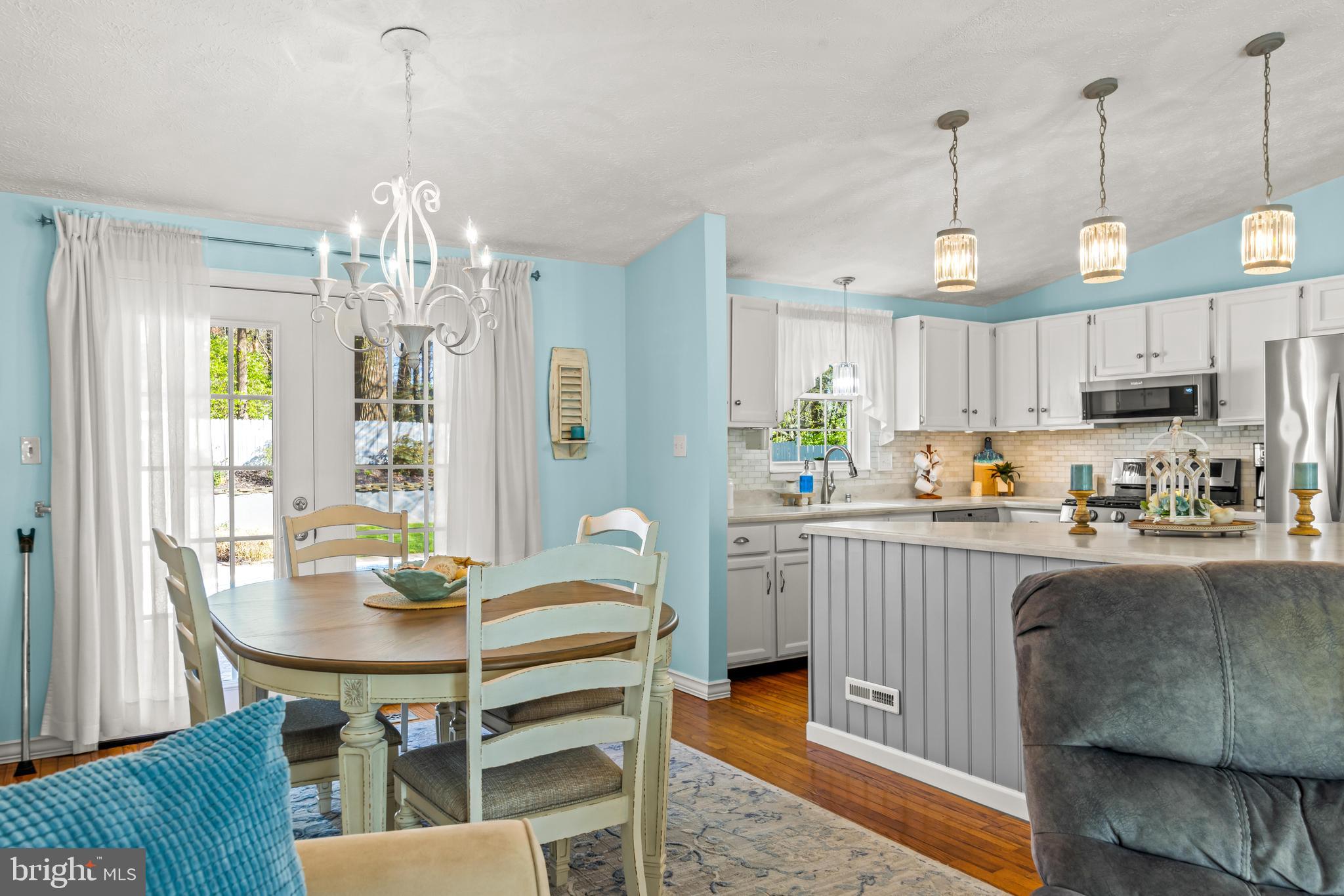 15 Yew Road Baltimore, MD 21221 - Photo 10 of 61 a view of a dining room and livingroom with furniture wooden floor a chandelier