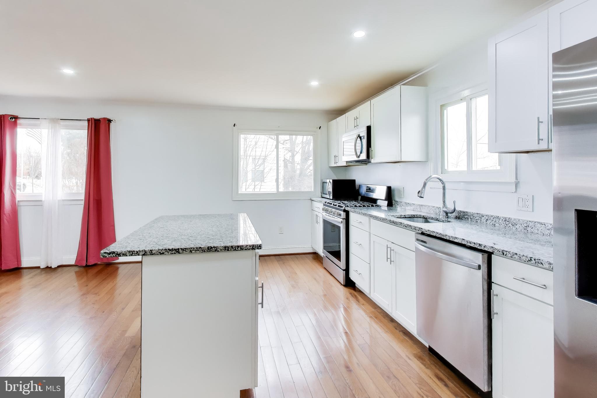 1028 Ward Street Laurel, MD 20707 - Photo 12 of 39 a kitchen with stainless steel appliances granite countertop a sink and cabinets
