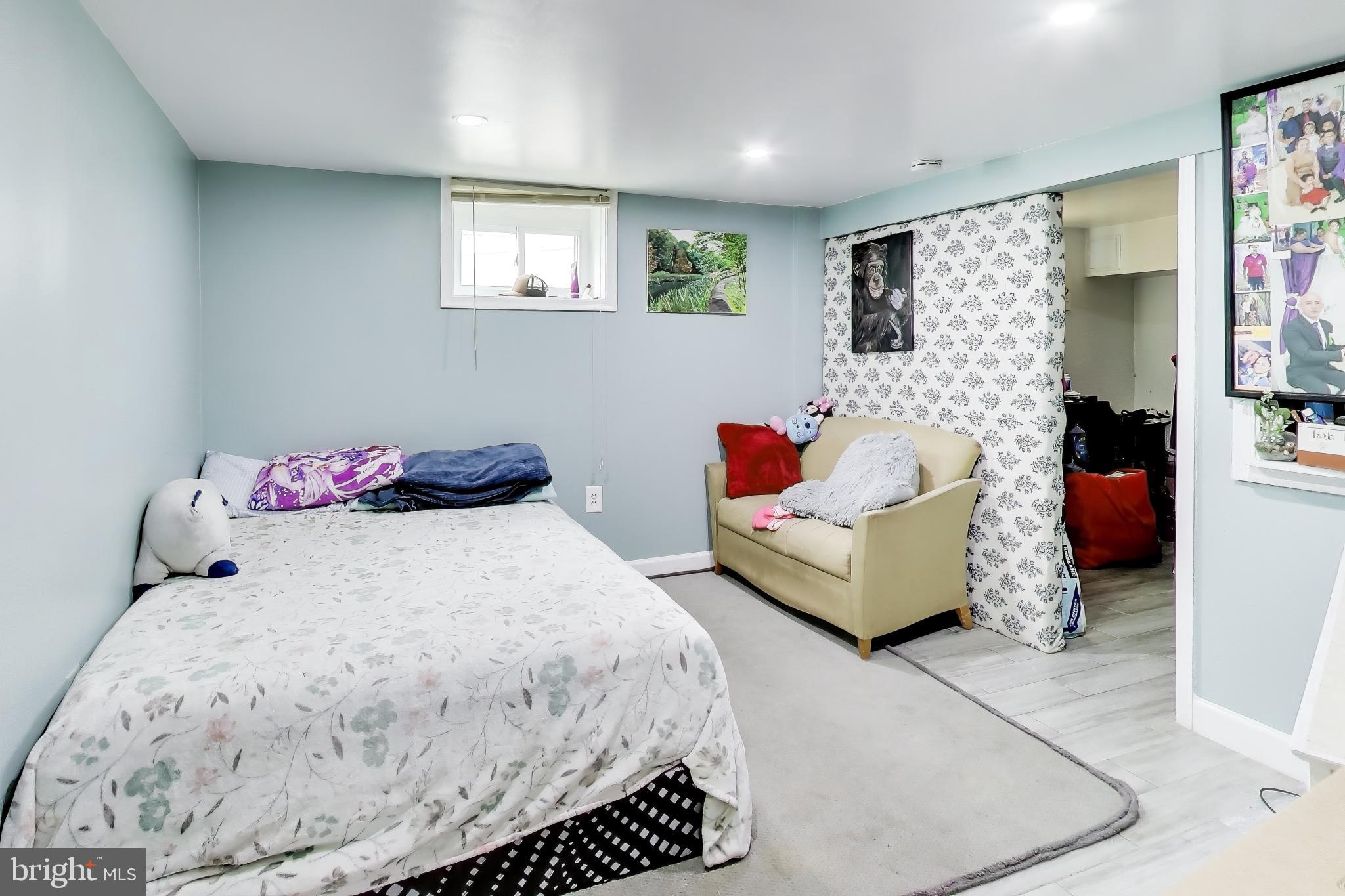 1028 Ward Street Laurel, MD 20707 - Photo 25 of 39 a bedroom with a bed and a couch
