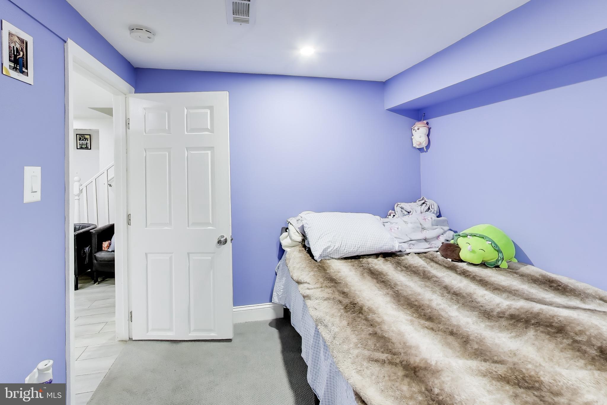 1028 Ward Street Laurel, MD 20707 - Photo 30 of 39 a bedroom with a bed and a flat screen tv