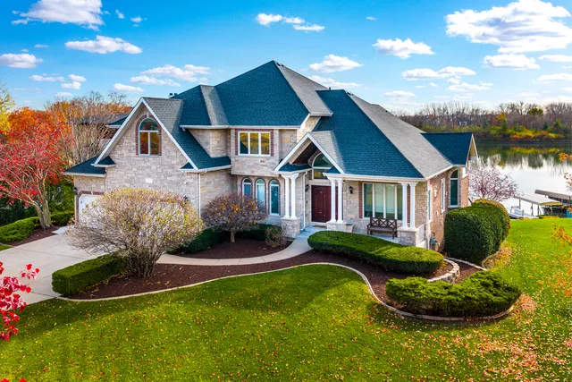 a front view of house with yard and green space