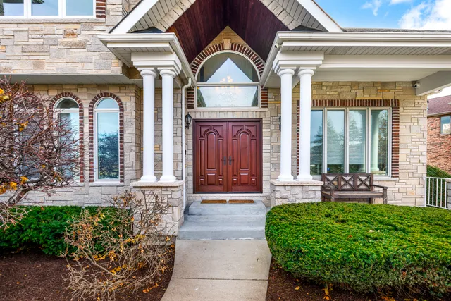 a view of an entryway with wooden floor and door