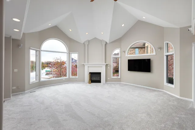 a view of a livingroom with furniture staircase and a ceiling fan