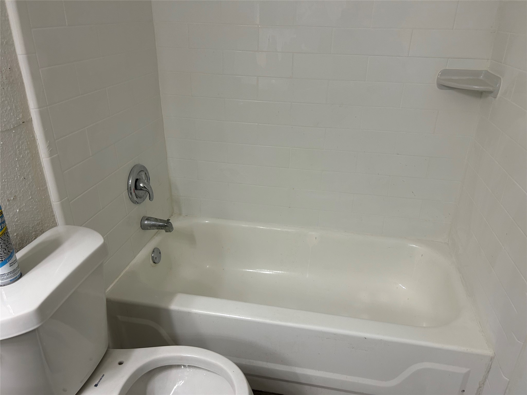 a bathroom with a toilet and a bathtub