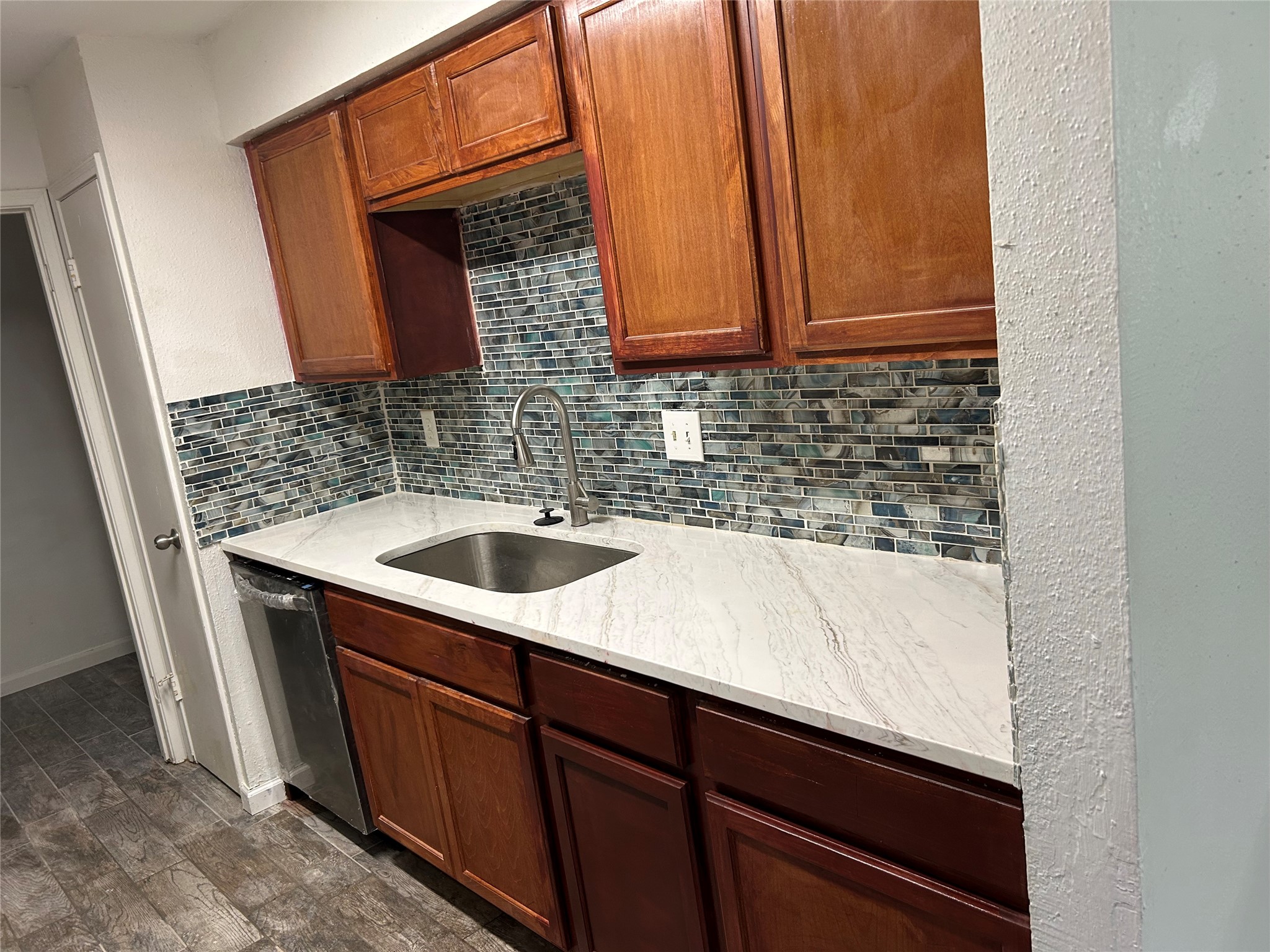 9700 Leawood Boulevard, Unit 1407 Houston, TX 77099 - Photo 2 of 10 a sink with a sink and cabinets