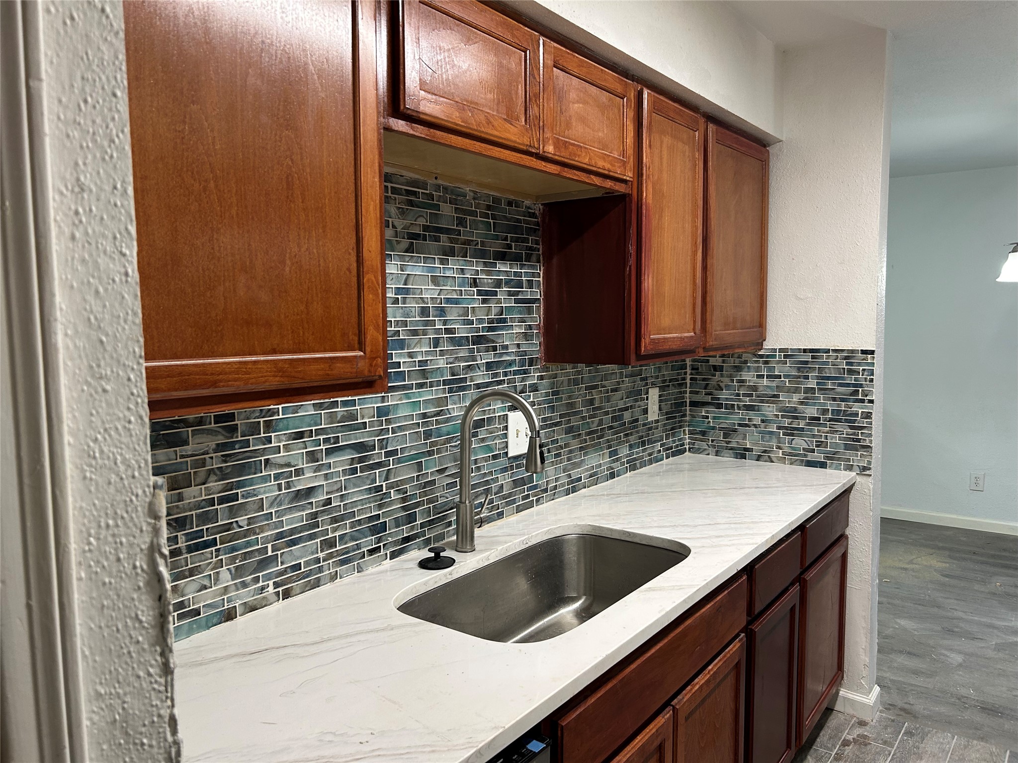 9700 Leawood Boulevard, Unit 1407 Houston, TX 77099 - Photo 5 of 10 a kitchen with a sink and cabinets