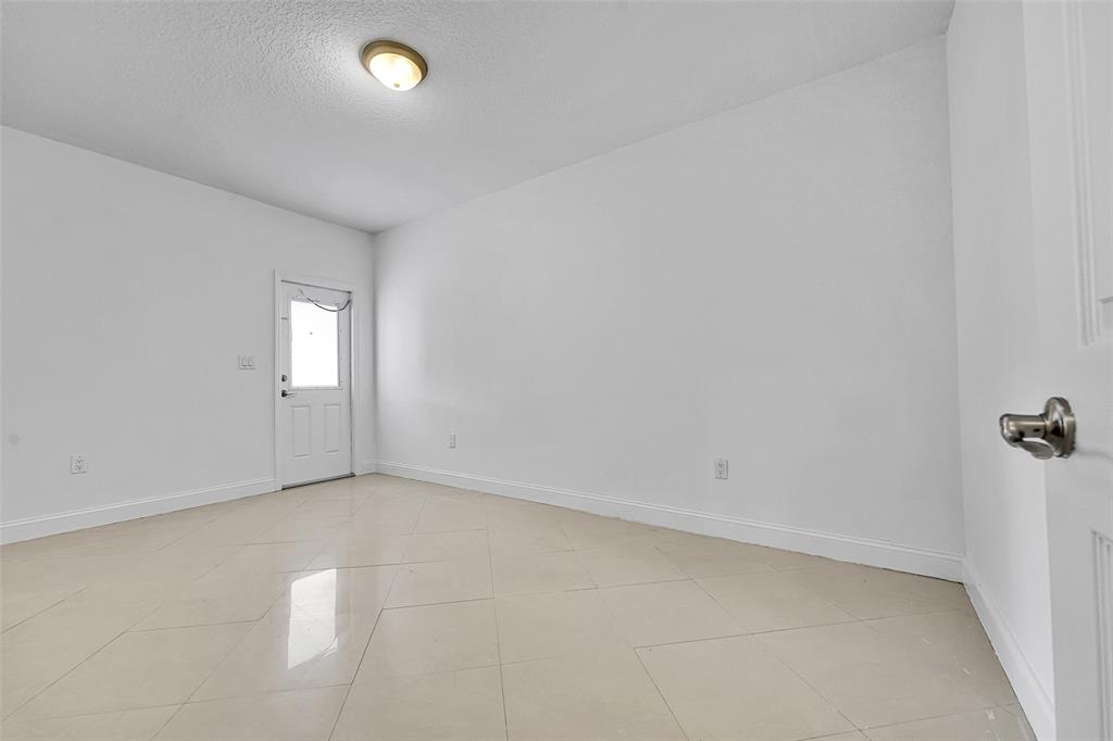 2634 Southwest 188th Avenue, Unit 2634 Miramar, FL 33029 - Photo 13 of 48 wooden floor in an empty room with a window