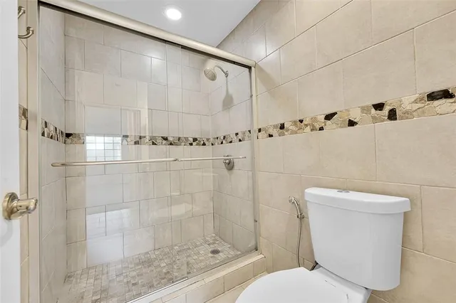 a bathroom with a toilet and shower