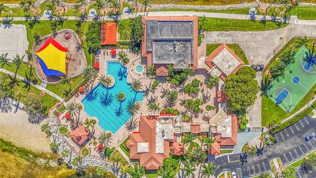 an aerial view of a houses with yard swimming pool and outdoor seating