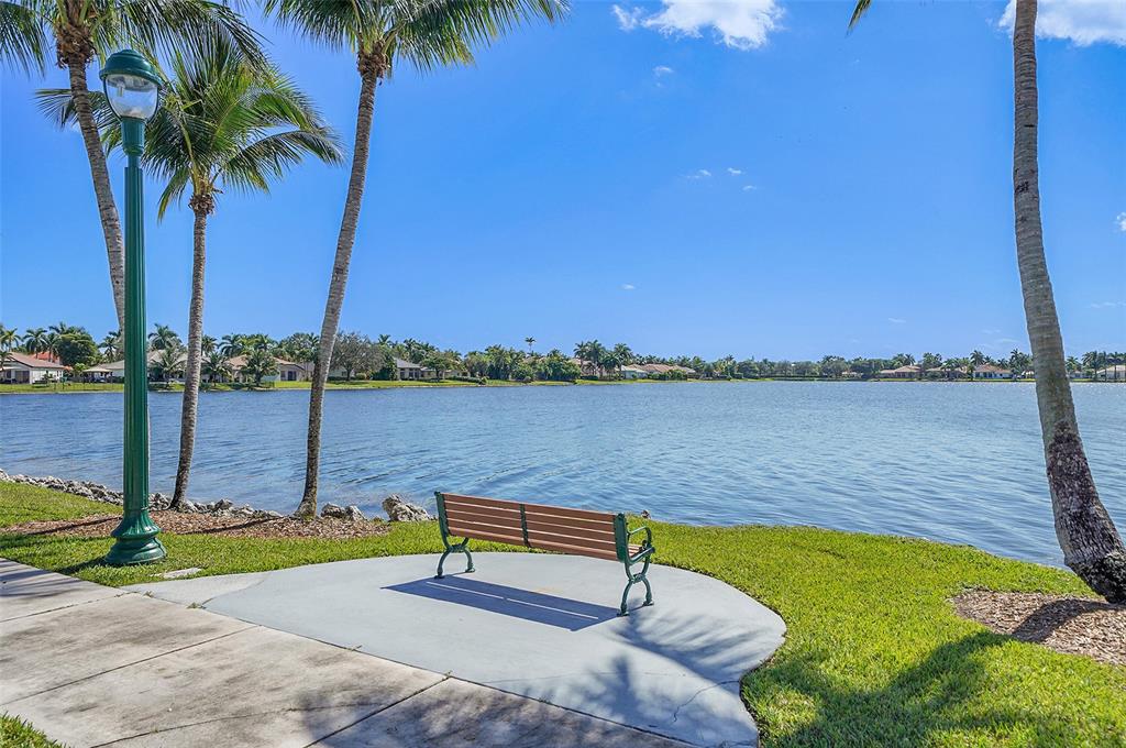 2634 Southwest 188th Avenue, Unit 2634 Miramar, FL 33029 - Photo 34 of 48 a view of a lake with couches and wooden fence