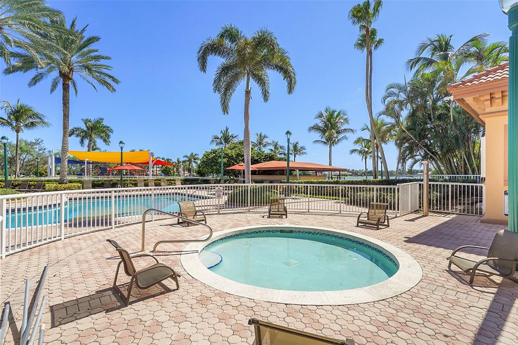 2634 Southwest 188th Avenue, Unit 2634 Miramar, FL 33029 - Photo 41 of 48 a view of a swimming pool with a seating space and potted plants