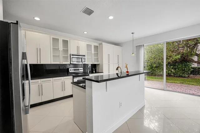 a kitchen with stainless steel appliances granite countertop a stove and a refrigerator