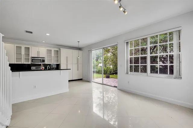 a view of a kitchen with an empty space and a window