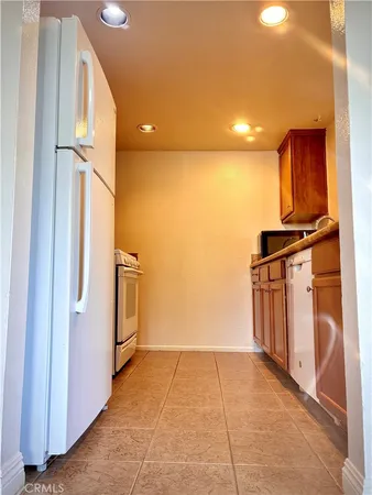 a view of kitchen with furniture and refrigerator