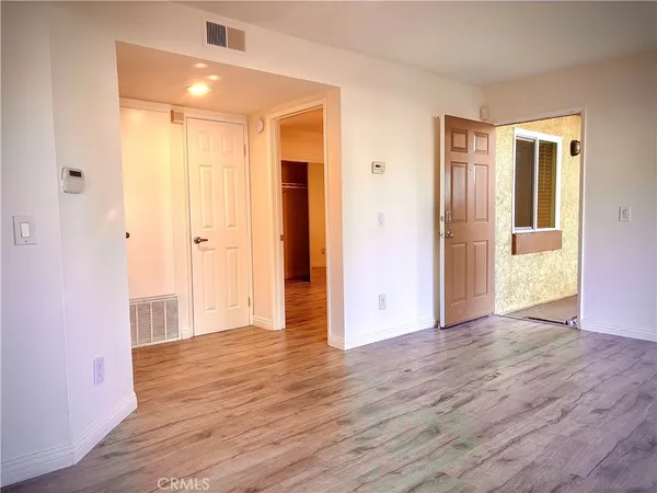 a view of hallway with wooden floor