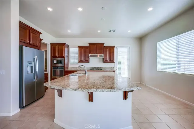 a kitchen with stainless steel appliances granite countertop a stove and a sink