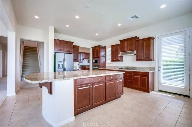 a kitchen with stainless steel appliances granite countertop wooden cabinets a sink and dishwasher