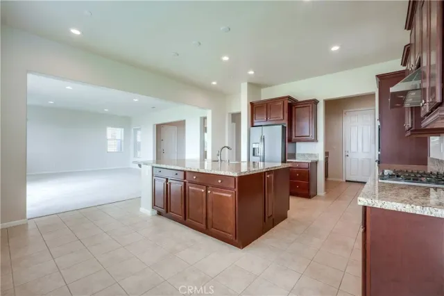 a kitchen with stainless steel appliances granite countertop a sink stove and cabinets