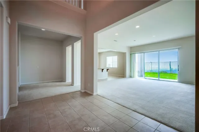 a view of empty room with a kitchen and fireplace