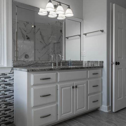 296 Rock Bridge Road Gallatin, TN 37066 - Photo 17 of 45 a close view of a granite countertop sink vanity and a mirror