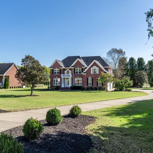 296 Rock Bridge Road Gallatin, TN 37066 - Photo 2 of 45 a view of a big house with a big yard plants and large trees
