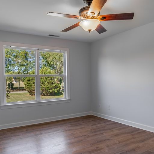 296 Rock Bridge Road Gallatin, TN 37066 - Photo 24 of 45 an empty room with wooden floor fan and windows