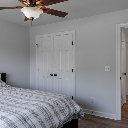 296 Rock Bridge Road Gallatin, TN 37066 - Photo 32 of 45 a bedroom with a bed and a chandelier