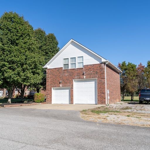 296 Rock Bridge Road Gallatin, TN 37066 - Photo 40 of 45 a front view of a house with a yard and garage