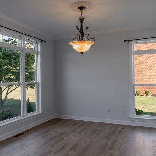 296 Rock Bridge Road Gallatin, TN 37066 - Photo 4 of 45 a view of an empty room with wooden floor and a window