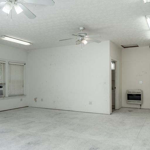 296 Rock Bridge Road Gallatin, TN 37066 - Photo 44 of 45 an empty room with chandelier fan and windows
