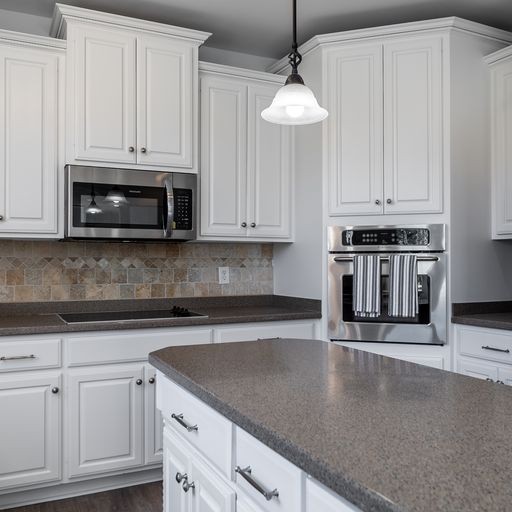 296 Rock Bridge Road Gallatin, TN 37066 - Photo 9 of 45 a kitchen with stainless steel appliances granite countertop a stove a sink and white cabinets