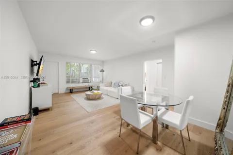 a view of a dining room with furniture and a window
