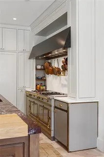 a kitchen with a stove and a refrigerator