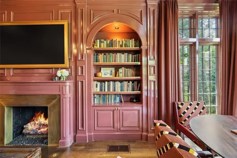 a living room with fireplace furniture and a flat screen tv