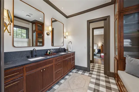 a spacious bathroom with a double vanity sink a mirror and a shower